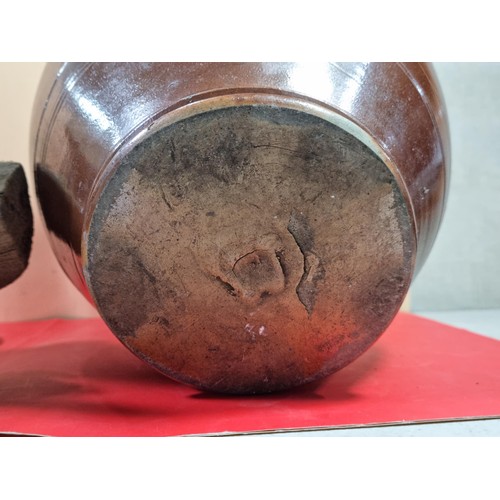 23 - A lidded stoneware brown coloured urn with lid with chips to the top along with a washing clothes do... 