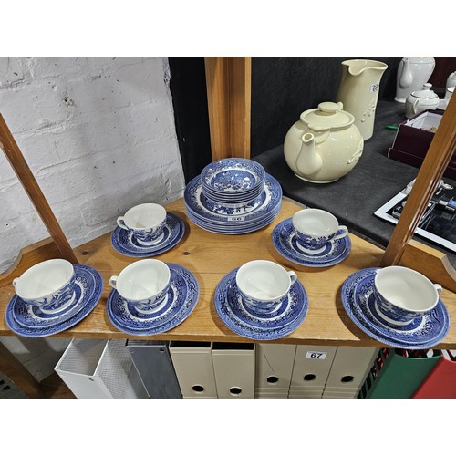 66 - A partial willow pattern dinner set to include 6x trios, 6x dinner plates and 6x bowls all in good o... 