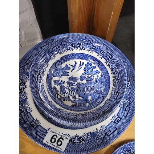 66 - A partial willow pattern dinner set to include 6x trios, 6x dinner plates and 6x bowls all in good o... 