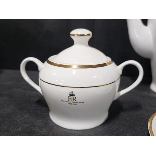 70 - A good quality 4 person tea set in white with gilding to the rim and side, to commemorate Queen Eliz... 