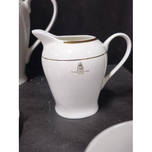 70 - A good quality 4 person tea set in white with gilding to the rim and side, to commemorate Queen Eliz... 