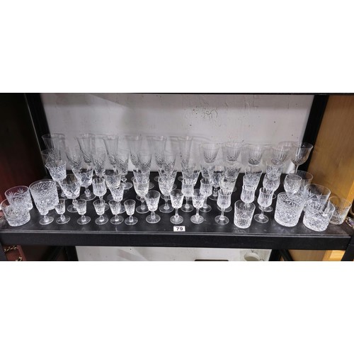 79 - A large collection of assorted cut glass crystal drinking glasses to include a total of 58 glasses t... 