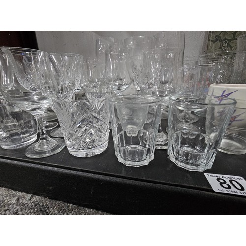 80 - A very large quantity of glass table ware and drinking glasses to include wine glasses, sherry glass... 