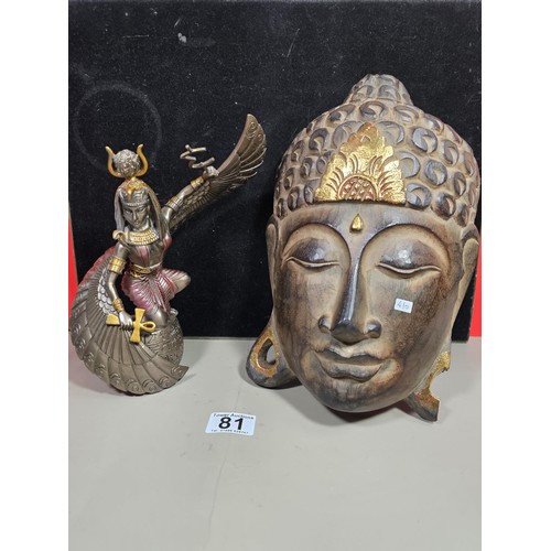 81 - A good quality wooden wall hanging in the form of a Buddha's head along with a resin Egyptian Goddes... 