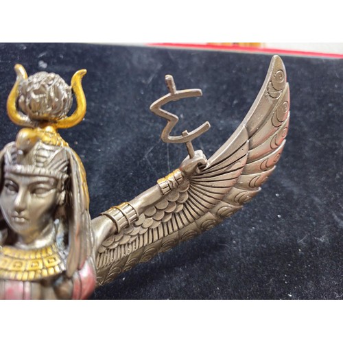 81 - A good quality wooden wall hanging in the form of a Buddha's head along with a resin Egyptian Goddes... 