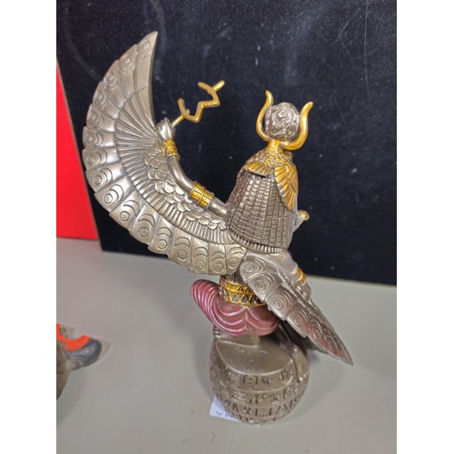 81 - A good quality wooden wall hanging in the form of a Buddha's head along with a resin Egyptian Goddes... 