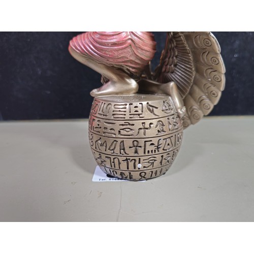 81 - A good quality wooden wall hanging in the form of a Buddha's head along with a resin Egyptian Goddes... 