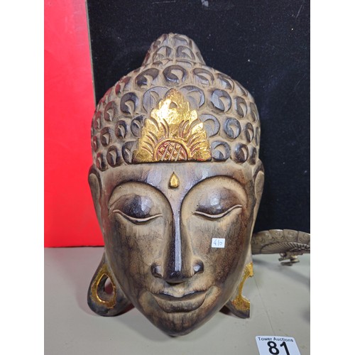 81 - A good quality wooden wall hanging in the form of a Buddha's head along with a resin Egyptian Goddes... 