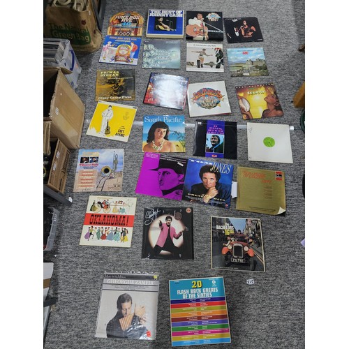 104 - A selection of LP vinyl records to include albums by Tom Jones, Shakin Stevens, Queen, Chet Atkins, ... 