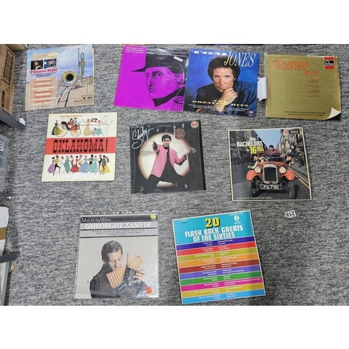104 - A selection of LP vinyl records to include albums by Tom Jones, Shakin Stevens, Queen, Chet Atkins, ... 