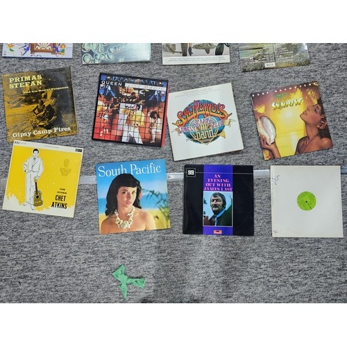 104 - A selection of LP vinyl records to include albums by Tom Jones, Shakin Stevens, Queen, Chet Atkins, ... 