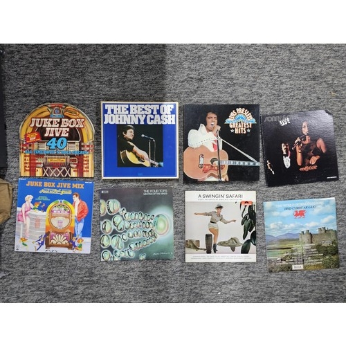 104 - A selection of LP vinyl records to include albums by Tom Jones, Shakin Stevens, Queen, Chet Atkins, ... 