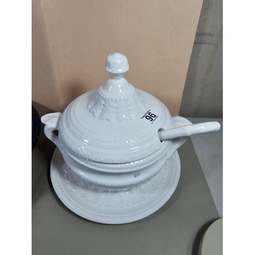 96 - A good quality white large lided tureen with a large ladle standing on a matching tray with a leaf d... 