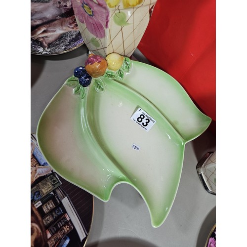 83 - A shelf full of collectables to including picture plates 2x Arthur Wood vases in an art deco style, ... 