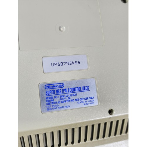 133 - A cased Super Nintendo Entertainment System in a rare Original Nintendo case, model number SNSP-001A... 