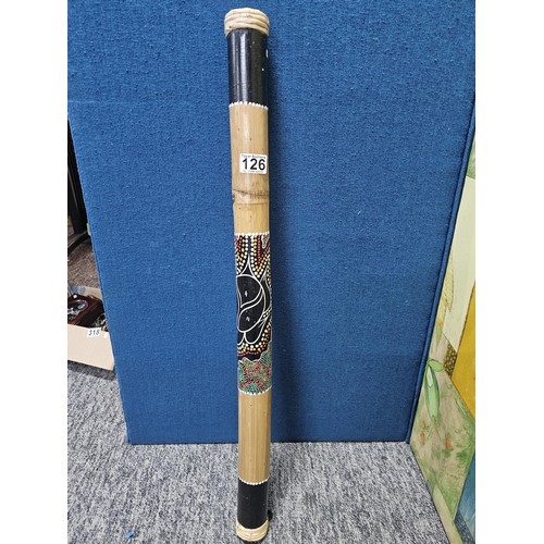 126 - A good quality hand painted rain stick in wood with the image of a turtle to the front surrounded wi... 