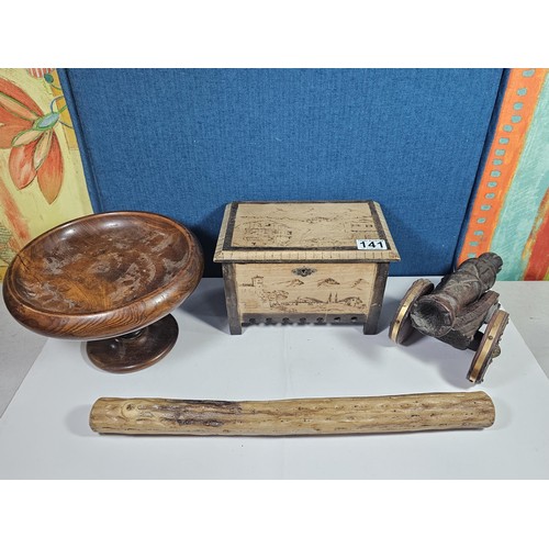 141 - A selection of wooden items to include a wooden hand turned bowl on a pedestal stand along with a wo... 