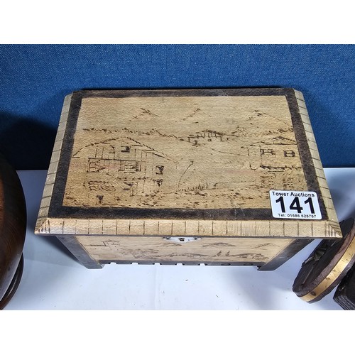 141 - A selection of wooden items to include a wooden hand turned bowl on a pedestal stand along with a wo... 