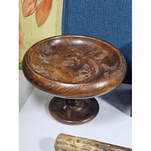 141 - A selection of wooden items to include a wooden hand turned bowl on a pedestal stand along with a wo... 
