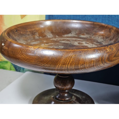 141 - A selection of wooden items to include a wooden hand turned bowl on a pedestal stand along with a wo... 