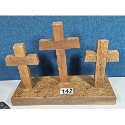 142 - A collection of wooden items to include 3x wooden crosses set into a wooden base along with 3x rusti... 