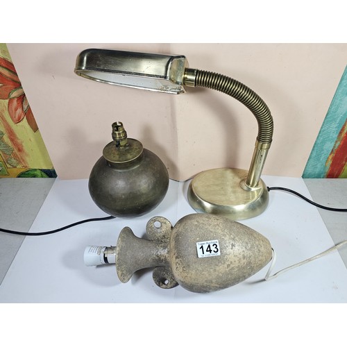 143 - A collection of three lights to include a brass table top light with a flexible neck, a brass lamp w... 