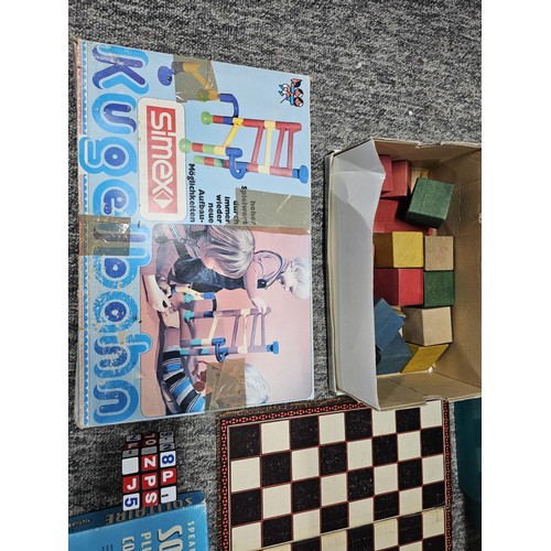 157 - Green crate containing a large quantity of assorted toys to include wooden building blocks, chess bo... 