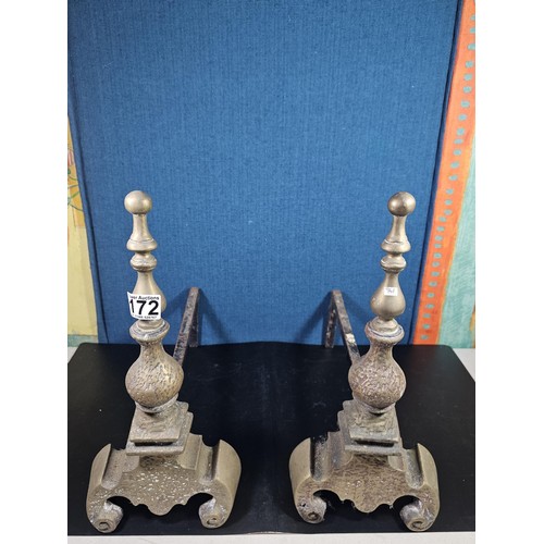 172 - A pair of good quality antique cast iron fire dogs standing on scrolled feet with finial top, both i... 