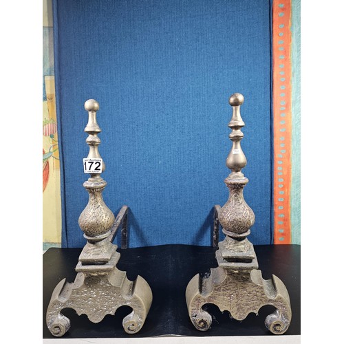172 - A pair of good quality antique cast iron fire dogs standing on scrolled feet with finial top, both i... 