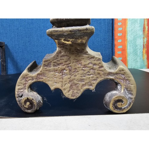 172 - A pair of good quality antique cast iron fire dogs standing on scrolled feet with finial top, both i... 