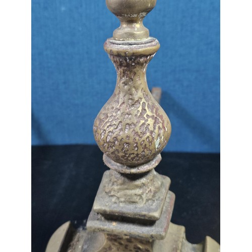 172 - A pair of good quality antique cast iron fire dogs standing on scrolled feet with finial top, both i... 