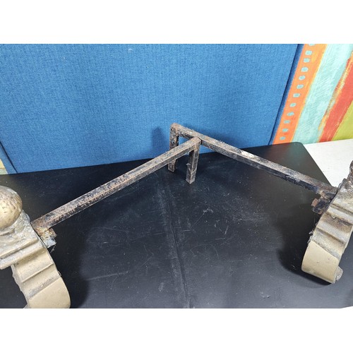 172 - A pair of good quality antique cast iron fire dogs standing on scrolled feet with finial top, both i... 