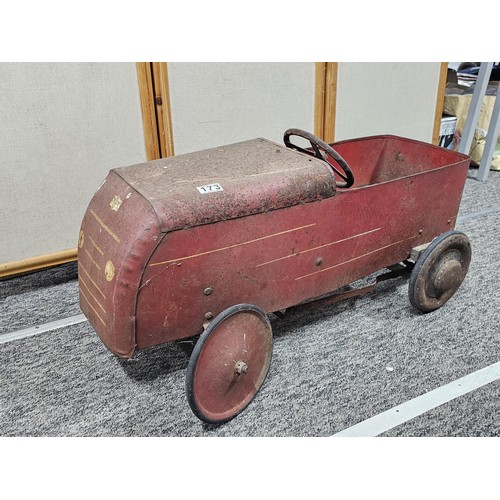 173 - A vintage metal Teddy pedal car in red in need of restoration, the car is stamped Teddy to the front... 