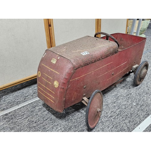173 - A vintage metal Teddy pedal car in red in need of restoration, the car is stamped Teddy to the front... 