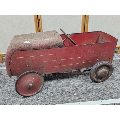 173 - A vintage metal Teddy pedal car in red in need of restoration, the car is stamped Teddy to the front... 