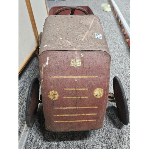 173 - A vintage metal Teddy pedal car in red in need of restoration, the car is stamped Teddy to the front... 