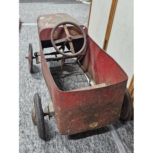 173 - A vintage metal Teddy pedal car in red in need of restoration, the car is stamped Teddy to the front... 