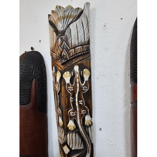 176 - A collection of 4 wall hanging original wooden ethnic face masks, 1 is in striking red, blue and yel... 