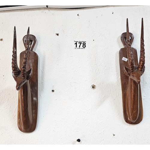 178 - A pair of antique hand carved antelope wall hangers made out of a solid piece of wood, the antelope ... 