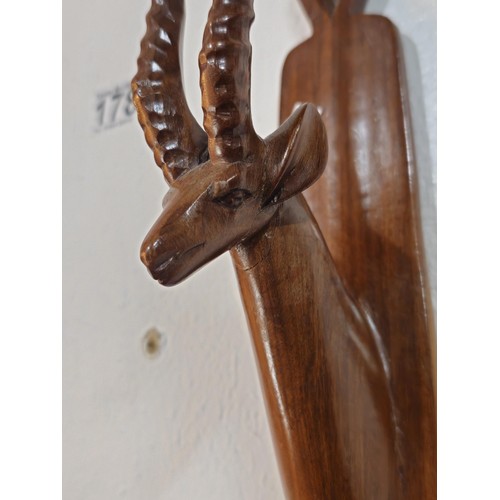 178 - A pair of antique hand carved antelope wall hangers made out of a solid piece of wood, the antelope ... 