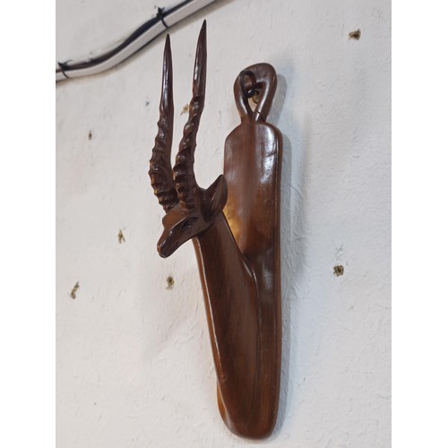 178 - A pair of antique hand carved antelope wall hangers made out of a solid piece of wood, the antelope ... 