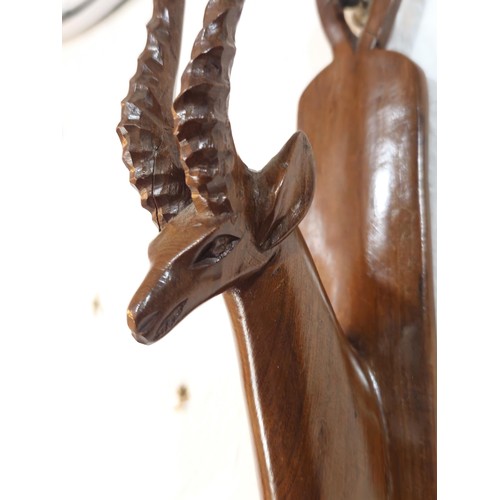 178 - A pair of antique hand carved antelope wall hangers made out of a solid piece of wood, the antelope ... 