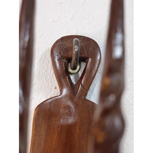 178 - A pair of antique hand carved antelope wall hangers made out of a solid piece of wood, the antelope ... 