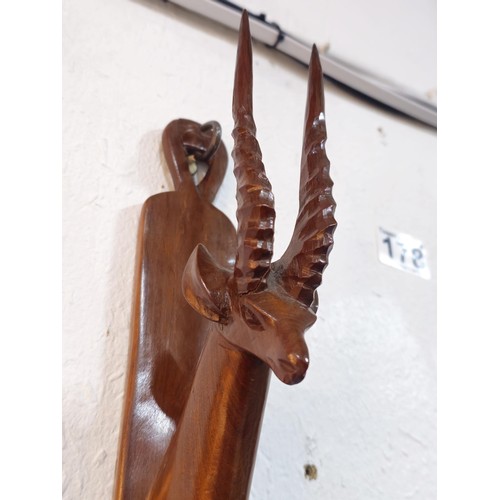 178 - A pair of antique hand carved antelope wall hangers made out of a solid piece of wood, the antelope ... 