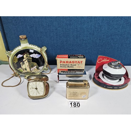 180 - A shelf containing a small quantity of collectables to include a Colibri ceramic tabletop lighter wi... 