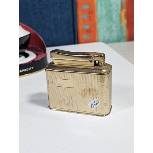 180 - A shelf containing a small quantity of collectables to include a Colibri ceramic tabletop lighter wi... 