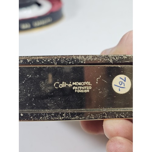 180 - A shelf containing a small quantity of collectables to include a Colibri ceramic tabletop lighter wi... 