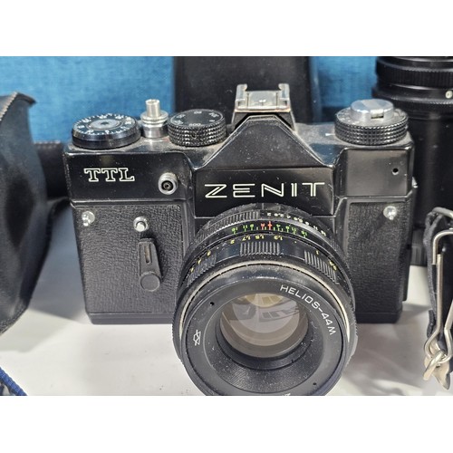 158 - Box of assorted cameras and accessories, to include a Minolta 7000 camera with a 35-70 lens, a Zenit... 