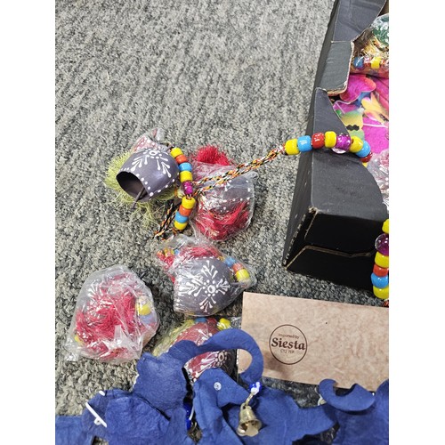 22 - A box containing a quantity of SAA mobile home made paper mobiles from Thailand, each packet contain... 