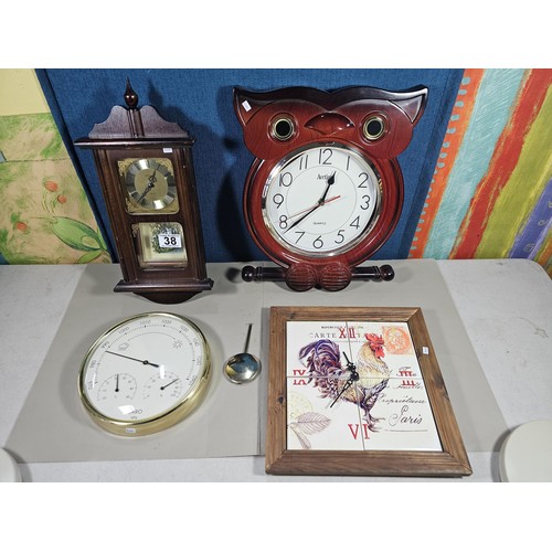 38 - A collection of 3 quartz battery operated clocks to include a wall hanging owl formed clock, a wall ... 